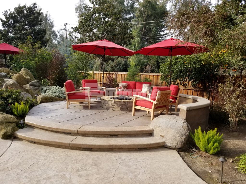 Bomanite Designer Backyard Ideal for Enterntaining with Imprinted Concrete Pool Deck and Exposed Aggregate Antico Firepit Seating and Cabana Flooring
