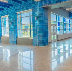 Grain Valley High School worked with Hollis + Miller Architects to renovate and expand their rapidly growing community and enlisted Musselman & Hall Contractors to install the Bomanite Modena SL Custom Polishing System for their main entrance and hallways with a blue glass and mirror glass mix of aggregates.