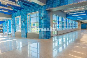 Grain Valley High School worked with Hollis + Miller Architects to renovate and expand their rapidly growing community and enlisted Musselman & Hall Contractors to install the Bomanite Modena SL Custom Polishing System for their main entrance and hallways with a blue glass and mirror glass mix of aggregates.