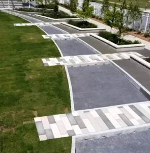 Owasso Redbud Festival Park used a custom Bomanite Chipped Shale Imprint for a stylized streambed that incorporated a splashpad designed by GH2 Architects and installed by Bomanite of Tulsa for the Owasso Community to enjoy
