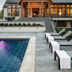 Luxury Home Builder, Hendel Homes chose Bomanite Licensee Concrete Arts for the spacious pool deck installation for their clients modern Tudor style new home, using Bomanite Sandscape Refined Antico Exposed Aggregate provides them with the sophistication and safety desired.