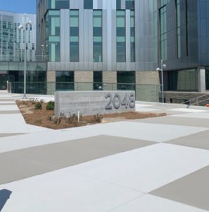 The Bomanite Toppings Systems were utilized at the new Cerner campus in Kansas City by Bomanite Licensee Musselman and Hall with an installation of Micro-Top XT in Nickel Gray Integral Color in a broom finish and Micro-Top ST with a French Gray Integral Color spray applied created consistency in application and color and mirrored the window and sheathing pattern on the buildings.