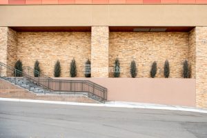 Colorado Hardscapes used the Bomanite Micro-Top ST system to correct a previous poured board formed wall installation and bring them up to code that now accent the exterior finishes on the building and provide a smooth and sleek appearance.