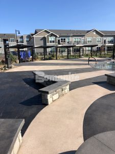Bomanite licensee Architectural Concrete & Design installed the pool deck area at Icon Apartment Homes at Ferguson Farms in Bozeman, MT, using Bomanite Exposed Aggregate Systems featuring contrasting bands of Bomanite Sandscape Texture and Bomanite Revealed.