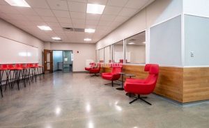 Custom glass aggregates in the colors Cranberry & Red Chunk were incorporated into this Bomanite VitraFlor custom polished concrete flooring, representing the school colors, and adding a stunning point of interest.