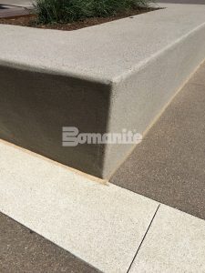 Bomanite Sandscape Texture and Bomanite Sandscape Refined were installed here to create the decorative concrete paved office building entry and planter walls.