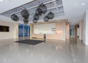 The Healthpeak Properties office in the Denver Tech Center boasts a beautiful Bomanite Modena Monolithic custom polished overlay with uniform aggregate exposure.